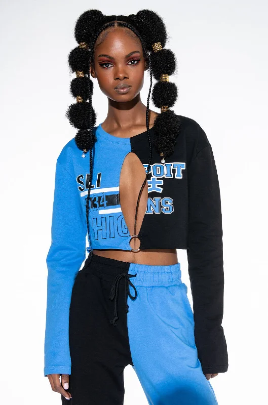 Women's cropped sweatshirt with a slogan graphic for a fun and expressive look TRYOUTS CUT OUT CROPPED SWEATSHIRT Women's cropped sweatshirt with a slogan graphic for a fun and expressive look TRYOUTS CUT OUT CROPPED SWEATSHIRT