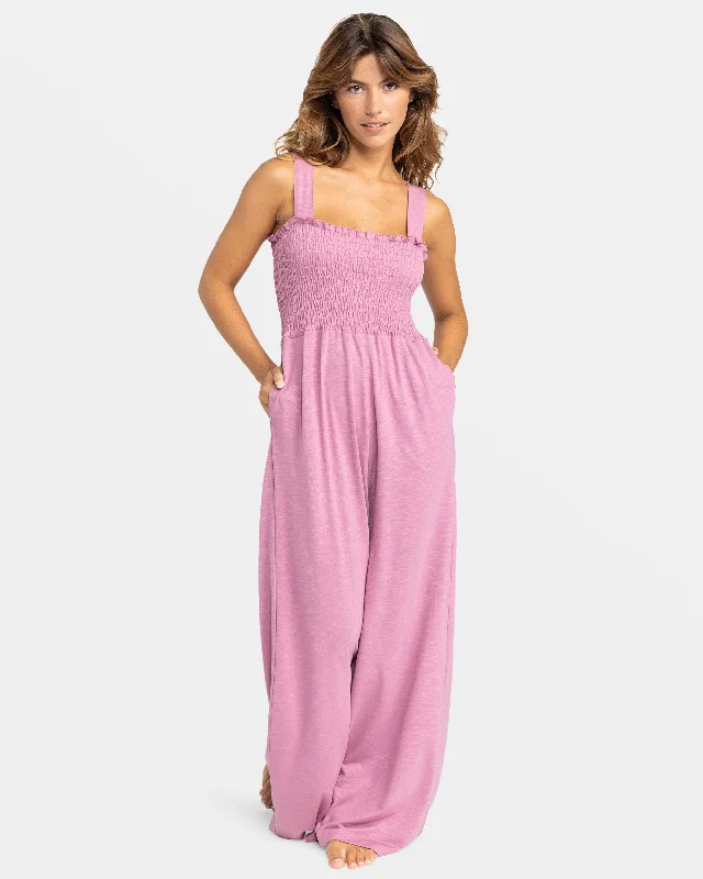 Women jumpsuits with fringe accents for a bohemian and fun - loving style Just Passing By Smocked Jumpsuit - Mauve Orchid Women jumpsuits with fringe accents for a bohemian and fun - loving style Just Passing By Smocked Jumpsuit - Mauve Orchid