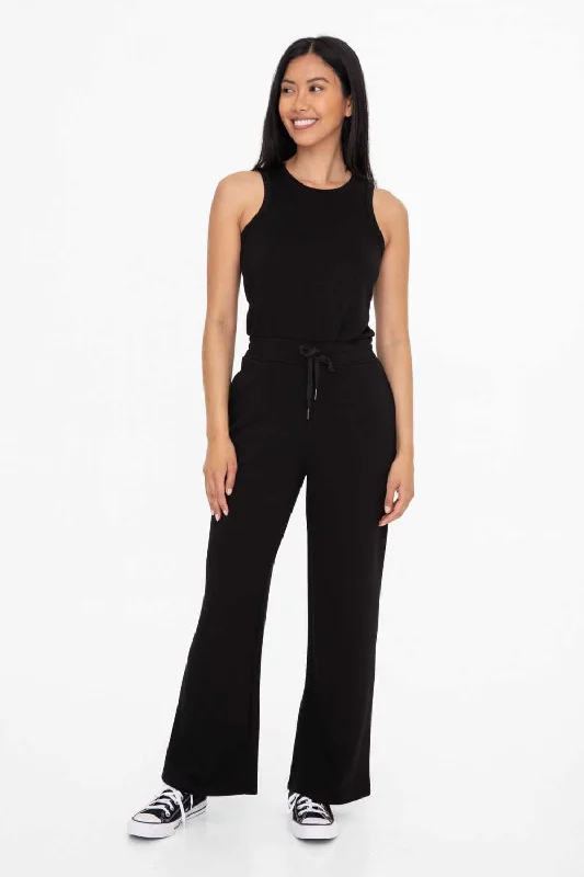 Women jumpsuits with tiered pants for added volume and style SHAUNAE KEYHOLE BLACK JUMPSUIT Women jumpsuits with tiered pants for added volume and style SHAUNAE KEYHOLE BLACK JUMPSUIT